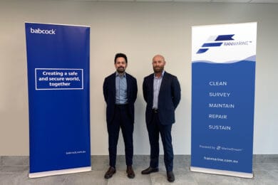 Representatives from Ʒջ and Franmarine standing in front of company banners